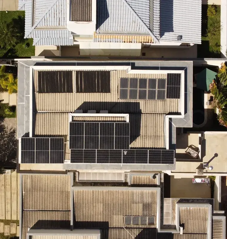 Vista aérea de cima de residência em condomínio em Sorocaba/SP com 12 módulos fotovoltaicos distribuídos em quatro grupos no telhado