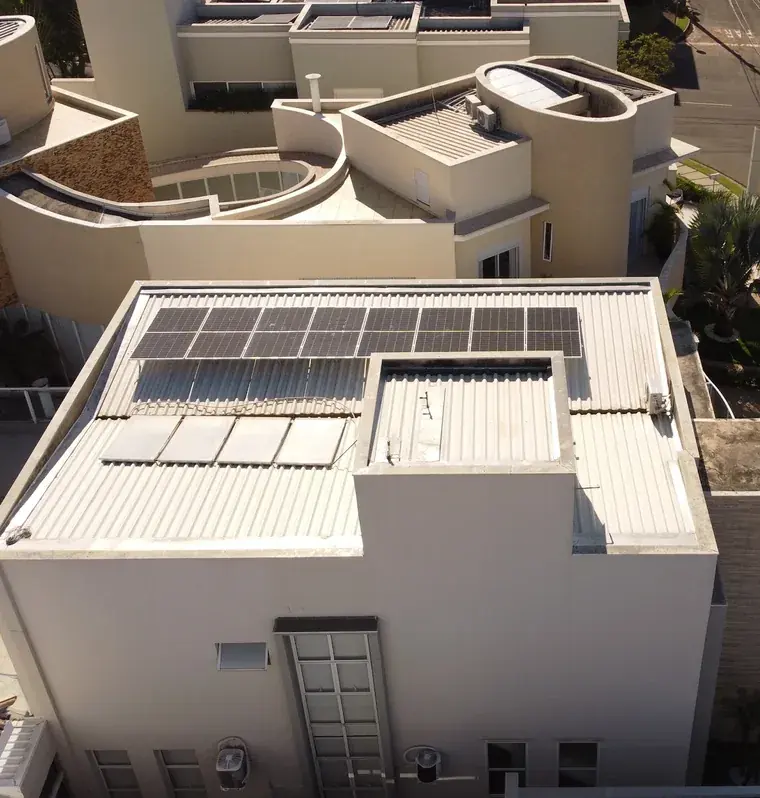 Vista aérea de residência em condomínio de Sorocaba/SP com uma fileira de 8 módulos fotovoltaicos no telhado metálico.
